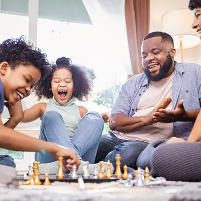 Image of family playing chess