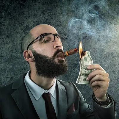 Image of man lighting cigar with cash