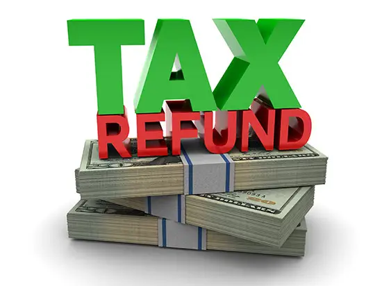 Image of TAX REFUND on top of a stack of money