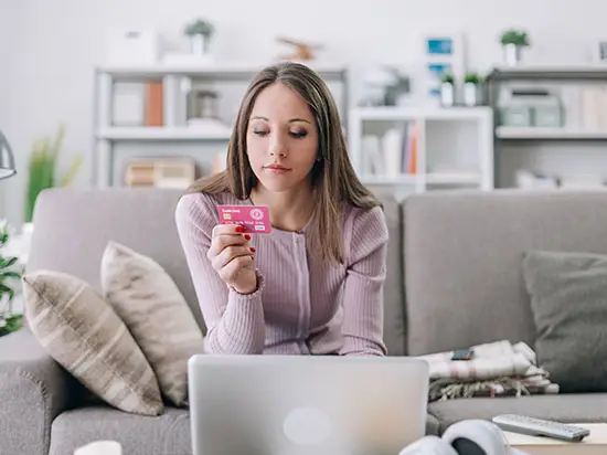 Image of yound woman holding a credit card
